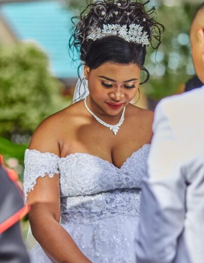 Bride standing in front of the groom.